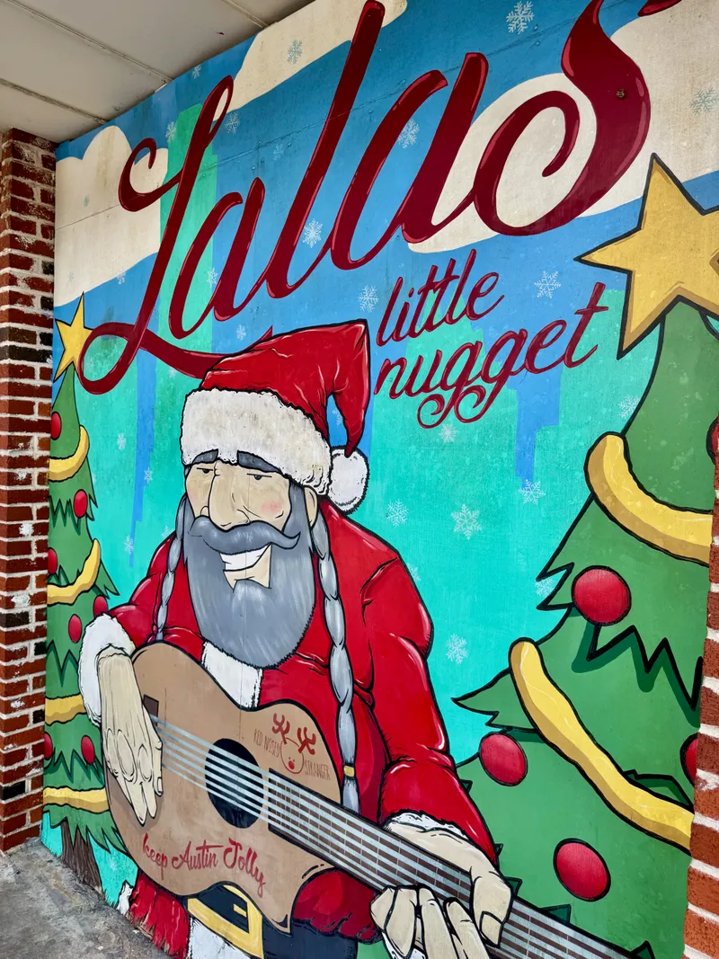Mural of Santa Claus playing a guitar with the words "Lala's little nugget" and "keep Austin Jolly"