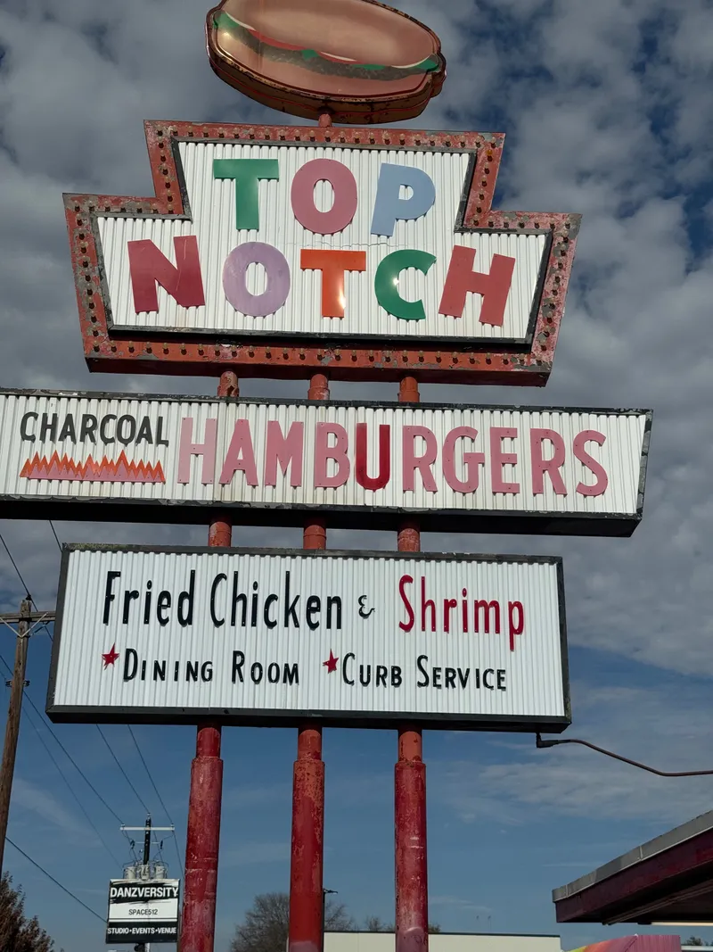 A vintage neon sign for "Top Notch" hamburgers, fried chicken, and shrimp.