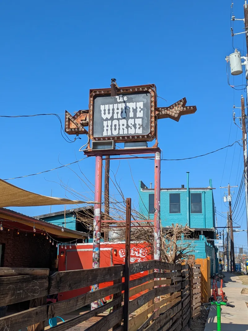 The White Horse bar sign with vintage marquee lights and arrow details.