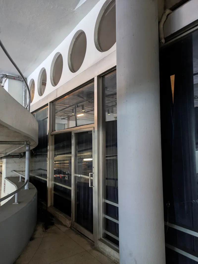 Exterior of a building with a spiral walkway and circular windows