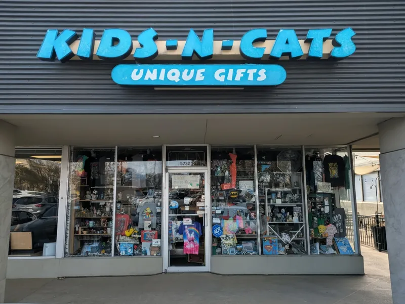 Exterior of a unique gifts store called Kids-N-Cats with a display window full of merchandise.